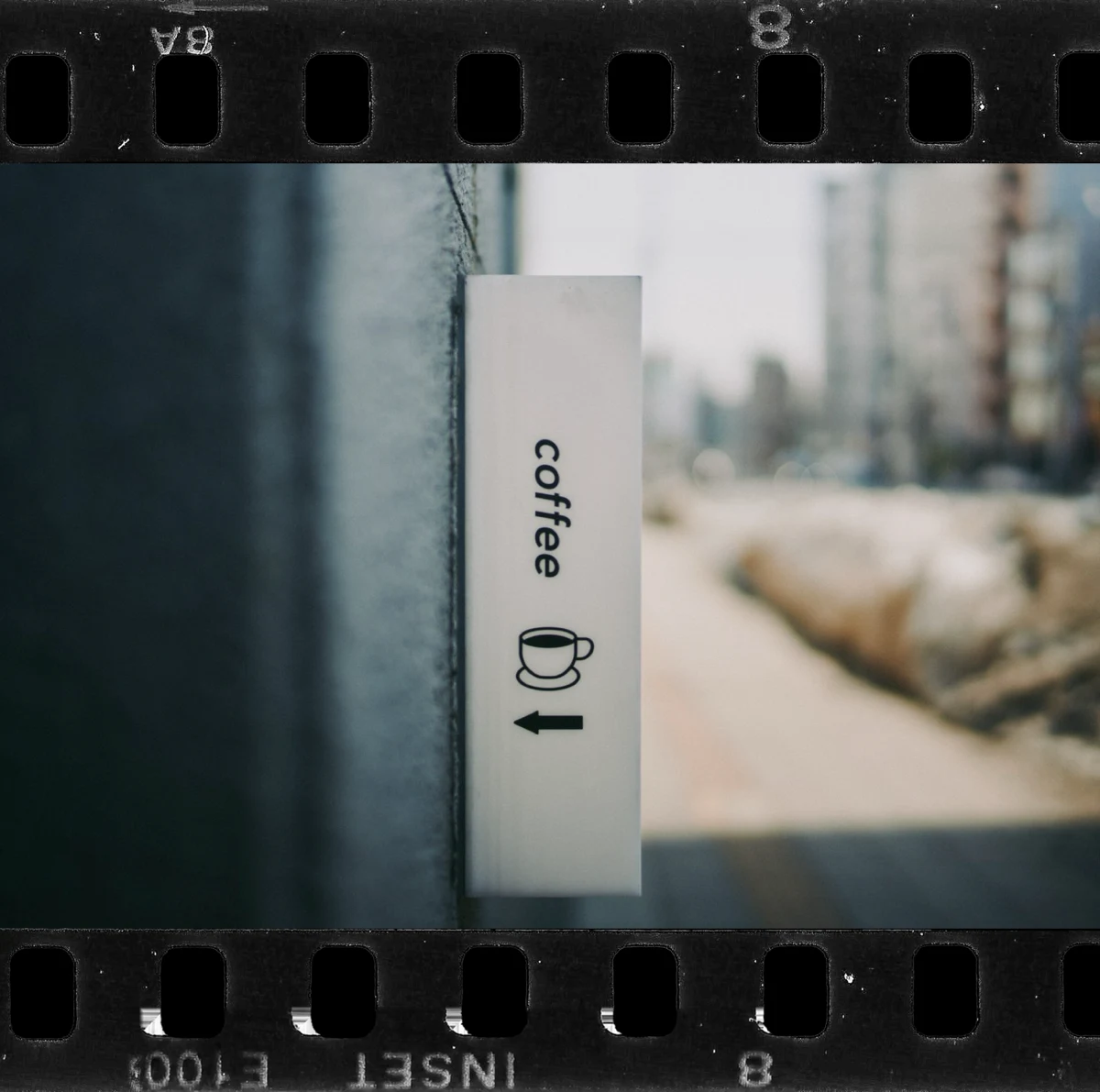 A coffee sign in a black 35mm frame