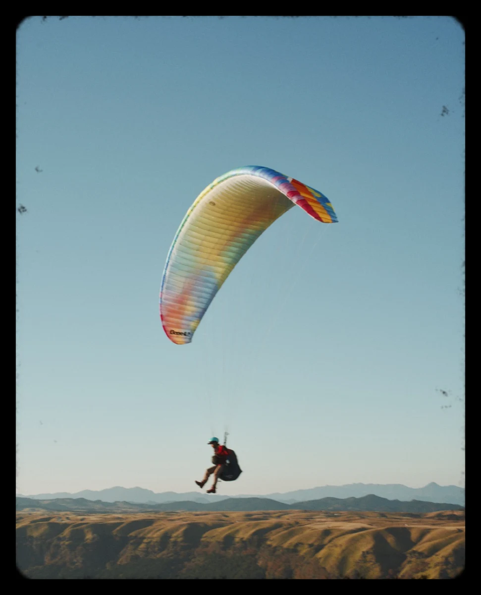 A paraglider in a rounded Letterbox border